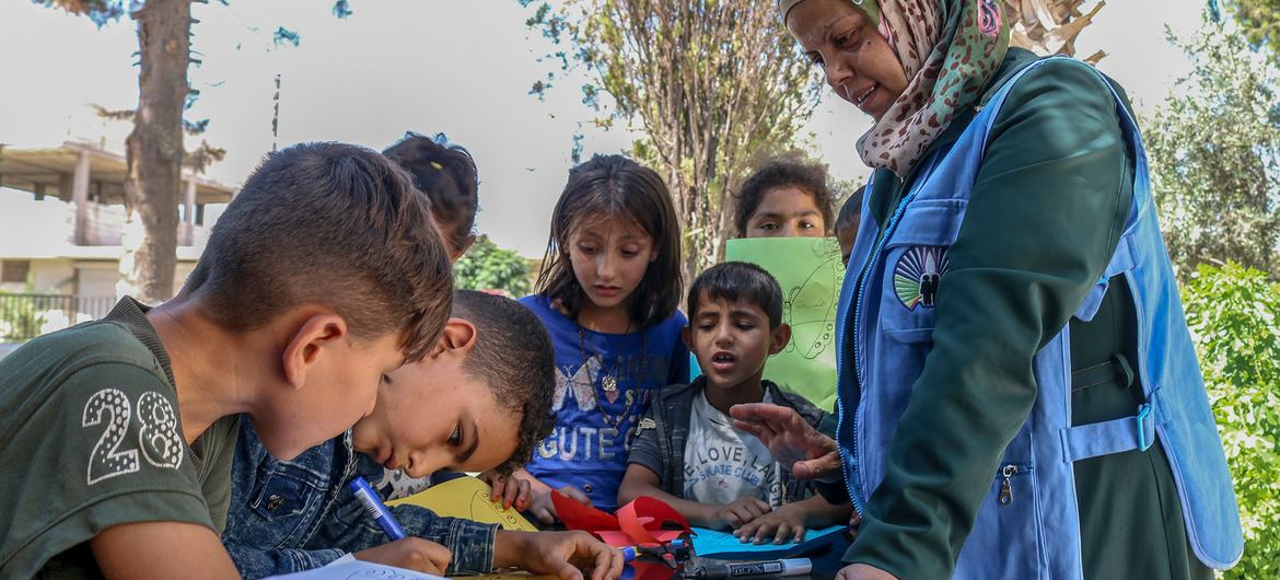 A UNICEF-supported teacher provides children with psychosocial support sessions at an integrated learning centre in east rural Aleppo, Syria.